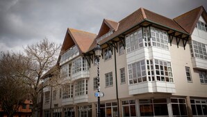 A multi-story building with a corner entrance, large windows, and a sign indicating short-term parking. - Toothbrush Apartments - Central Ipswich - St Peters St (Ipswich)