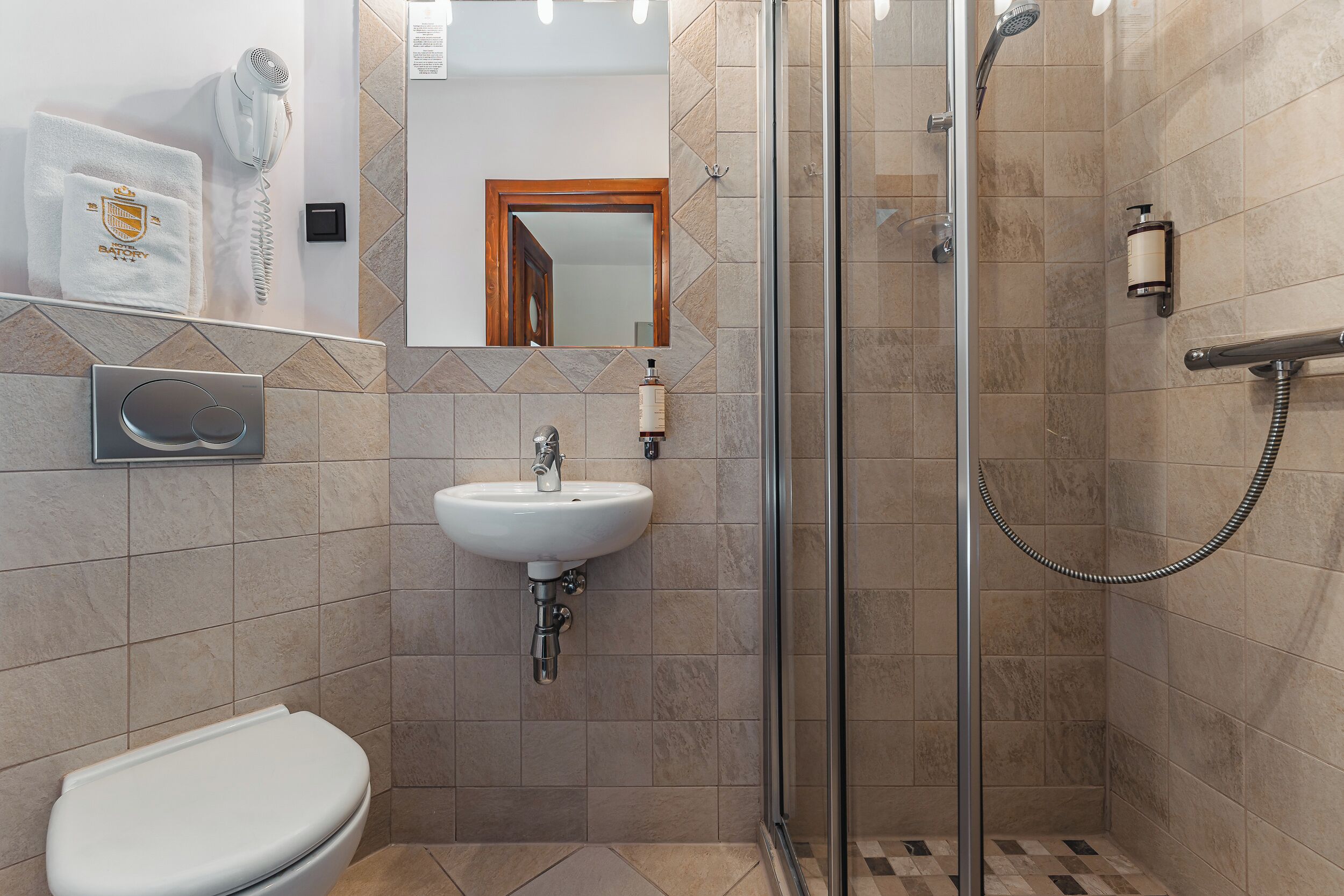Un baño moderno con ducha, inodoro y lavamanos.
