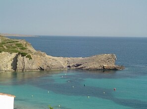 A coastal landscape with a rocky cliff and calm sea. - Apartment with Pool and Gardens (Arenal d'en Castell)