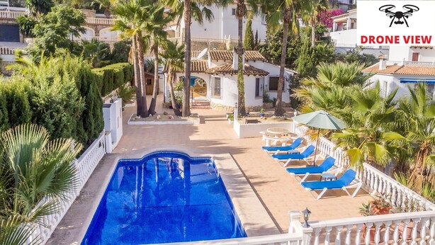 A pool area with a clear view of the surrounding buildings, palm trees, and a satellite dish. - Promana -Villa Ricarda with private pool 850m to the sea between Moraira & Calpe (Benissa)