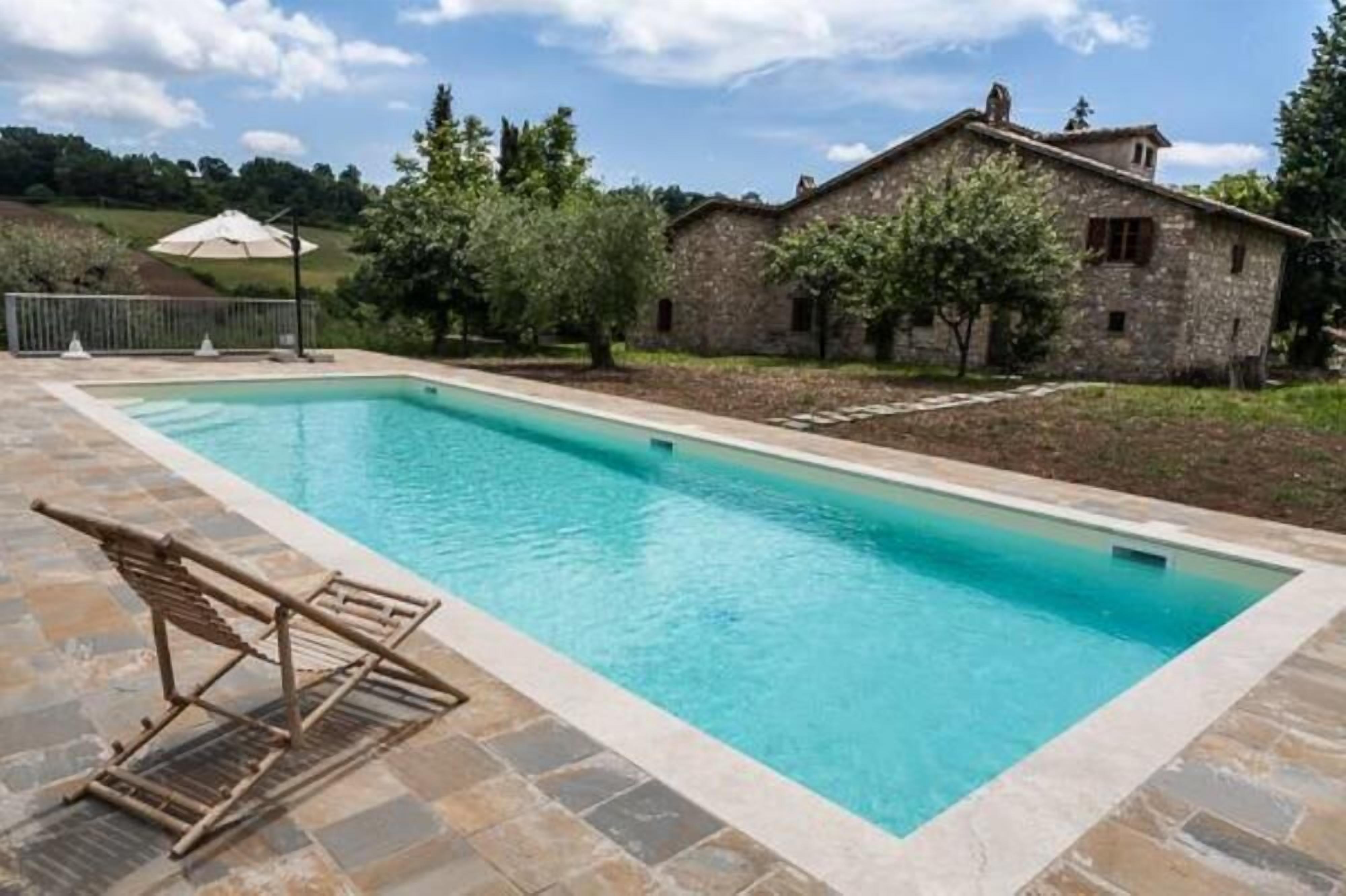 Manor house with private swimming pool surrounded by greenery