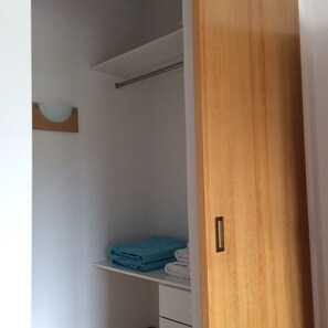 A wooden door leading to a closet with shelves holding folded towels and a blue towel. - Secluded villa boasting panoramic views to the sea - infinity pool and free Wifi (Tijarafe)