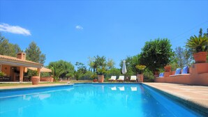 A swimming pool with lounge chairs and potted plants. - Country house with private pool & Tennis Court  - GREAT for families - Free Wifi (Bunyola)