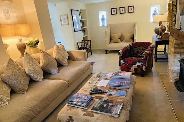 Beautiful sitting room with fireplace and antique furnishings.
