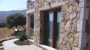 A stone building with a stone-paved entrance and a large window.