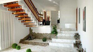 A modern staircase with wooden steps and a marble landing. - Luxury beachside villa  with private pool, terrace and sea views. (Benicassim)