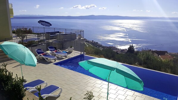 An infinity pool, sun loungers