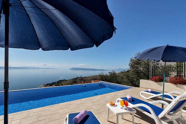 An infinity pool, pool loungers