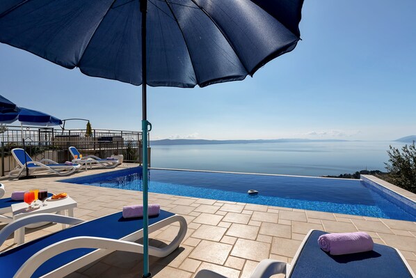 An infinity pool, pool loungers