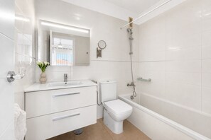 A modern bathroom with a toilet, sink, and shower. - FABULOUS DUPLEX C9 WITH PRIVATE POOL (Callao Salvaje)