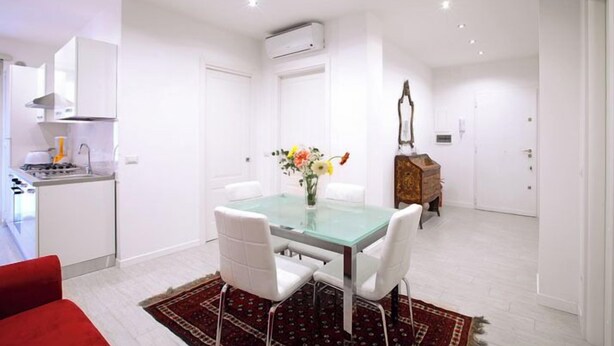 A modern kitchen with white cabinets, a built-in stove, and an air conditioning unit. - Luxury apartment 200 meters from St. Peter's basilica, in the heart of Rome (Roma)