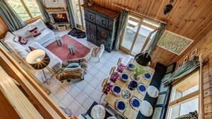 A cozy cabin interior with a fireplace, wooden walls, a dining area, and a sofa set. - Chalet l'Ange - La Tzoumaz, 4 Vallees (La Tzoumaz)