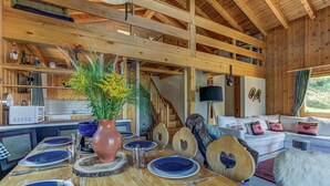 A wooden interior with a dining area, kitchen, and living space. - Chalet l'Ange - La Tzoumaz, 4 Vallees (La Tzoumaz)