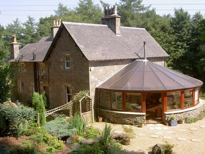 Large country house with outdoor hot tub and BBQ house and lovely gardens.