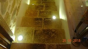 A stone staircase with a handrail and lighting fixtures. - Artistsvillas-Red Rose,unique,with breathless sea views and ecological pool. (Gaios)