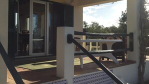 A covered outdoor area with a staircase leading to a patio. - 3-bedroom Villa with private swimming pool (Porches)