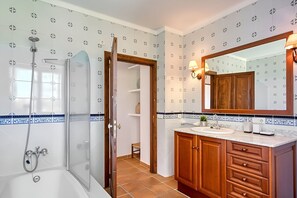 Een bad/douchecombinatie, een haardroger, een bidet, handdoeken