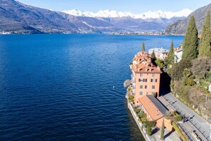 Un hôtel situé au bord de l’eau, doté d’un long balcon, avec une vue imprenable sur les montagnes et une vue dégagée sur le lac.