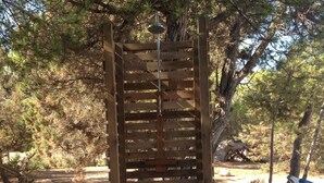 A wooden pergola structure in a natural setting with trees and a clear sky. - House / Villa - San Francisco Javier (Sant Francesc de Formentera)