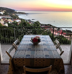 Enjoy a serene ocean view from this balcony, where you can sit and take in the sights of the surrounding buildings and sea.