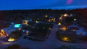 A nighttime view of a rural property with multiple buildings, a swimming pool, and well-lit pathways. - Hacienda NOA/secluded estate/practice golf/enjoy the view and great pool (Grohote, Island of Šolta)