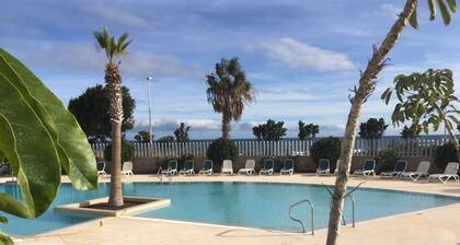 Modern two floor apartment right by the beach with pool, patio and paddle court