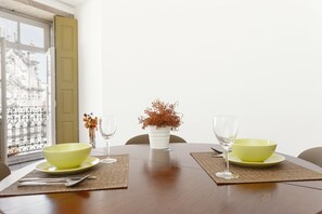 Enjoy a romantic dinner for two at this elegant table setting, complete with fine china and a beautiful floral arrangement.