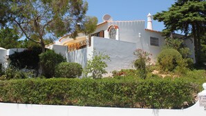 A white building with a satellite dish, a chimney, and a balcony with a railing. - Spacious luxury villa with A/C near beach with private pool (Carvoeiro)
