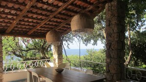 An outdoor dining area with a table and chairs, a patterned floor, and a view of the sea. - Villa in Maratea   Walking Distance From The Beach  CIN-IT076044C203105001 (Acquafredda,  Maratea)