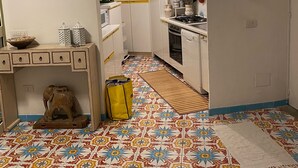 A kitchen with white cabinets, a stove, and a patterned floor. - Villa in Maratea   Walking Distance From The Beach  CIN-IT076044C203105001 (Acquafredda,  Maratea)