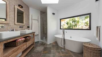 Bathtub, hair dryer, towels, toilet paper