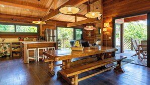 A spacious kitchen with wooden countertops, a large island, and modern appliances. - House / Villa - Porto vecchio (Porto-Vecchio)