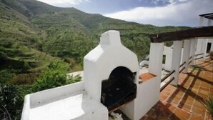 A white building with a black door, overlooking a mountainous landscape. - Ranch Studio in Quiet White Village Setting with shared Pool and Hot Tub (Castell de Ferro)