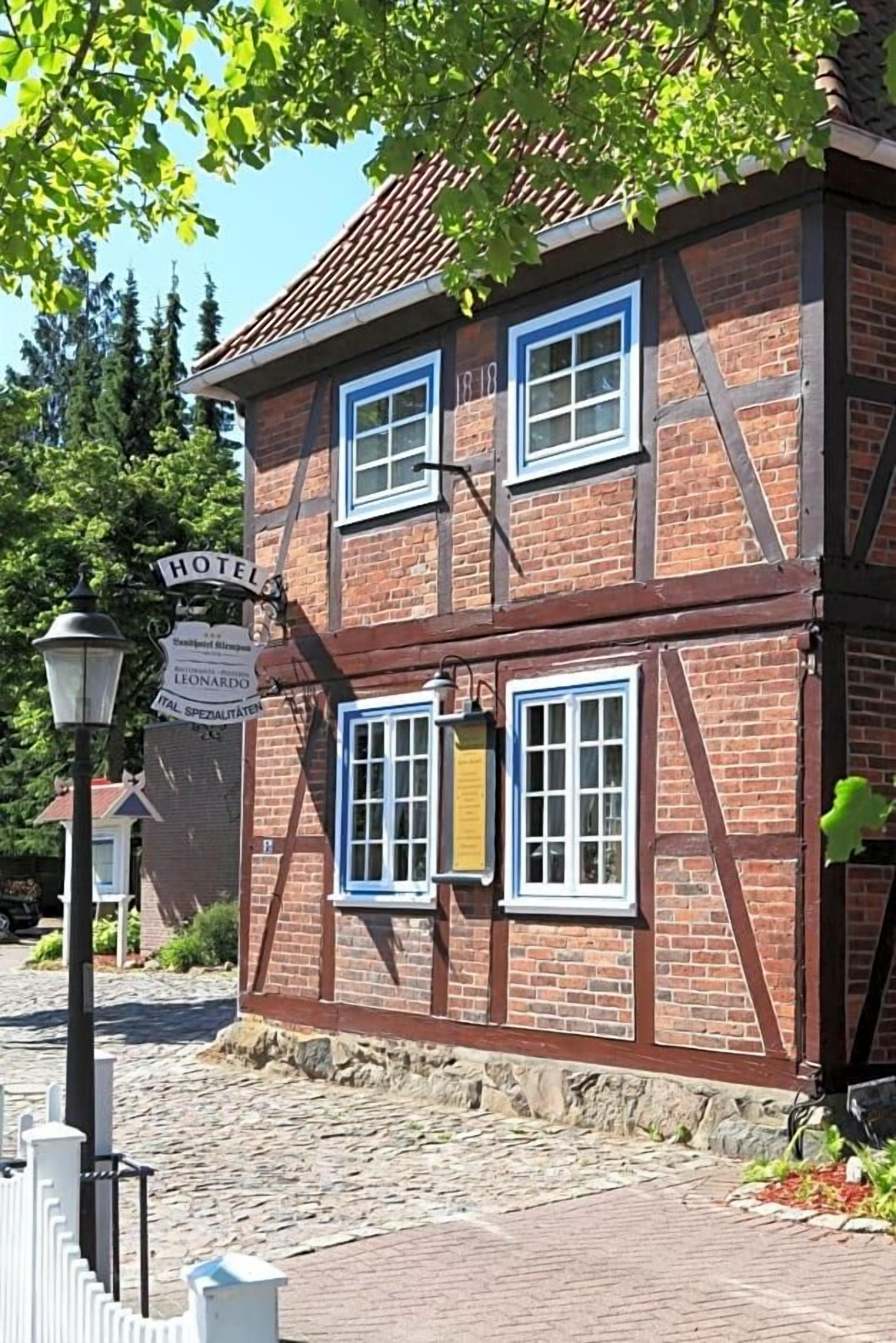 A traditional half-timbered building with a sign indicating it is a hotel.