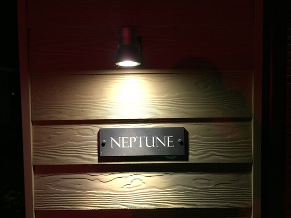 A sign with the word "NEPTUNE" on a wooden wall. - Luxury Contemporary Beach Lodge With Sand Dunes And River Views - Sleeps 6 (Heacham)