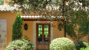 A yellow building with a tiled roof, a wooden door, and a small porch. - **PREMIUM PROPERTY** Beautiful finca with spectacular views and HEATED POOL (In Esporles)