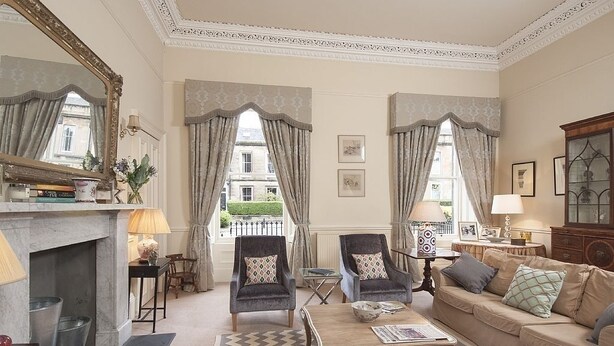 A spacious living room with a fireplace, two armchairs, a sofa, and a coffee table. - 1 Bellevue Terrace - sleeps 4 guests  in 2 bedrooms (Edinburgh)