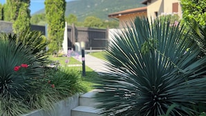 A pathway leading to a building with a mountain in the background.