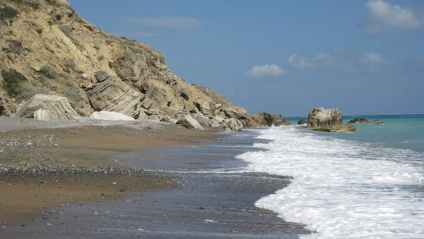 A beach with rocky cliffs and calm waves. - Luxury Villa With Private Pool, Landscaped Garden And Sea Views (Pissouri Bay)