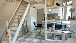 A loft-style living space with a staircase, a dining area, and a kitchen. - duplex apartment 50m from the Arcachon Basin (Lège-Cap-Ferret)