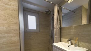 A modern bathroom with a walk-in shower, a large mirror, and a window. - High Standard Renovated Apartment for up to 8 persons, in the Centre (Zermatt)