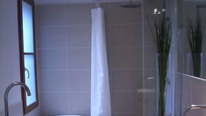 A modern bathroom with a freestanding bathtub, a vanity with a bowl sink, and a shower area. - STANDING APARTMENT, from the 18th Century, in the pedestrianized historic center (Montpellier)