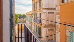 A narrow balcony with a metal railing, overlooking a street with buildings and trees. - Old Town (La Calatrava) Next to sea, quiet area, luminous.Wifi+Base Ipod/Iphone (Palma de Mallorca (Casco Antiguo - Old Town))