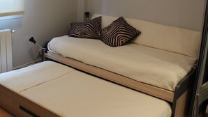 A compact room with a bed, a small table, and a radiator. - Apartment near Gros beach, ESS00033 (San Sebastián)