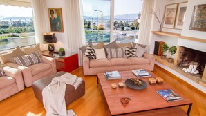 A modern living room with two sofas, a coffee table, and a fireplace.