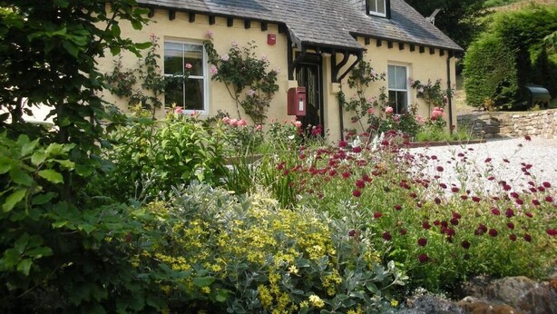 A traditional house with a sloped roof, a chimney, and a front door. - Former Lodge House to Swordale Castle (Evanton)