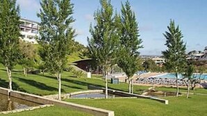 A hotel with a pool area, a grassy landscape, and a few trees. - Apartment/ flat - Lagos (Lagos)