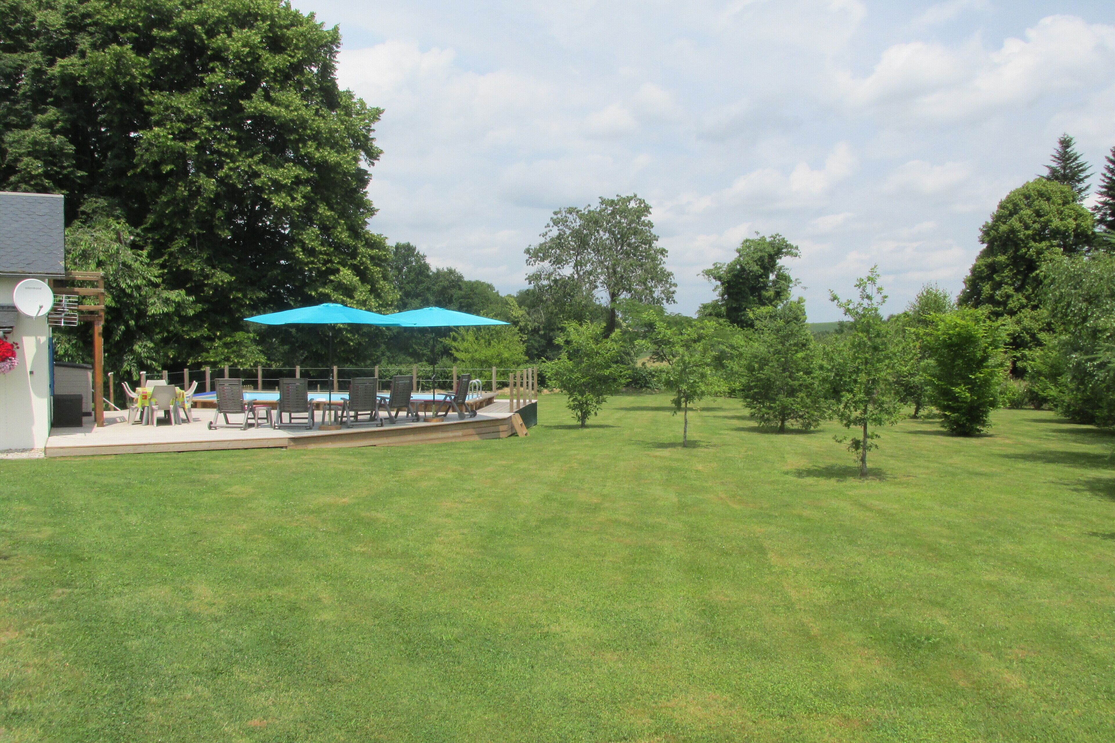 A patio area with outdoor seating and a blue umbrella.
