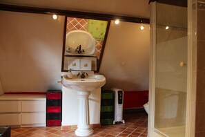 A bathroom with a pedestal sink, a toilet, a shower, and a bench with storage drawers. - Charming 18th century Normandy House by the river 150 km from Paris (Broglie)
