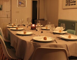 A dining table set for a meal with plates, cutlery, and wine glasses. - Stunning views of Snowdonia Mountains (Near Caernarfon)